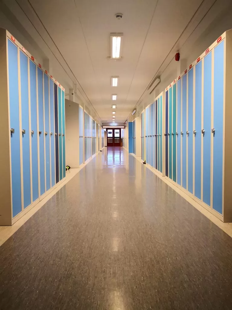 Photograph of a school hallway lined with lockers.